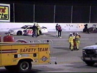 Driver barely escaped very serious injury and is helped by track safety officials